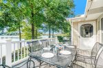 Upper level deck has a gas BBQ grill, outdoor furniture, and amazing waterfront views